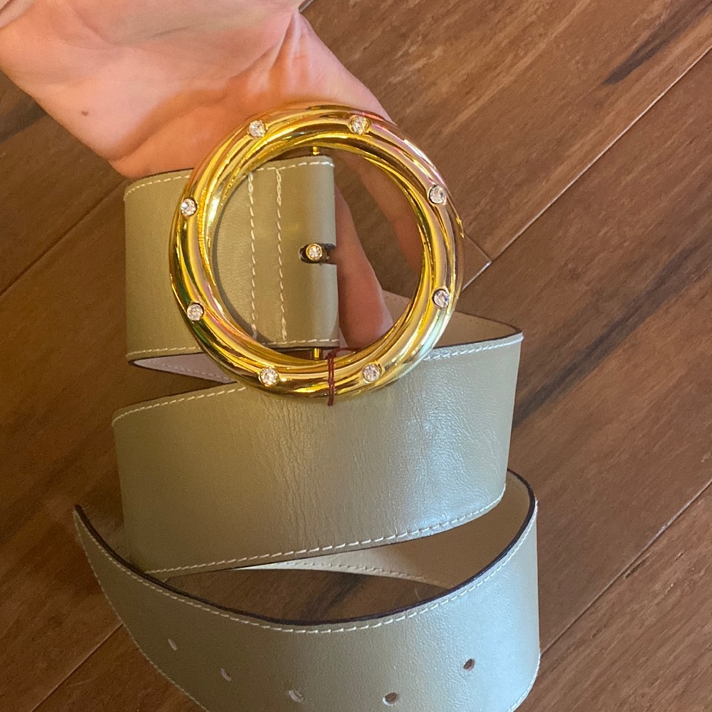 Vintage genuine leather belt with gold ring and rhinestone detail.